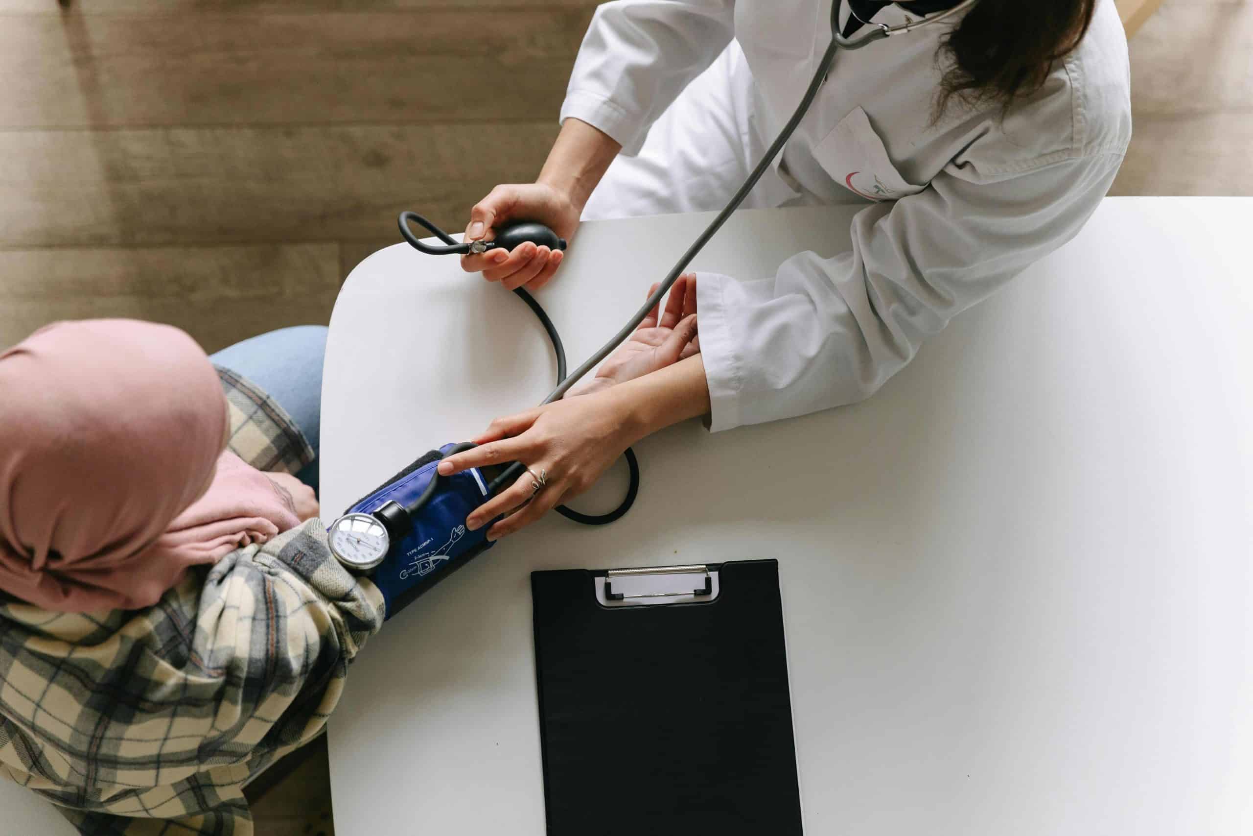 Primary care doctor taking blood pressure in Zurich clinic